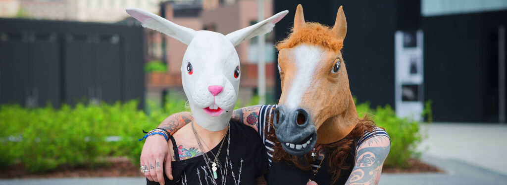 image of two people wearing rabbit and horse masks