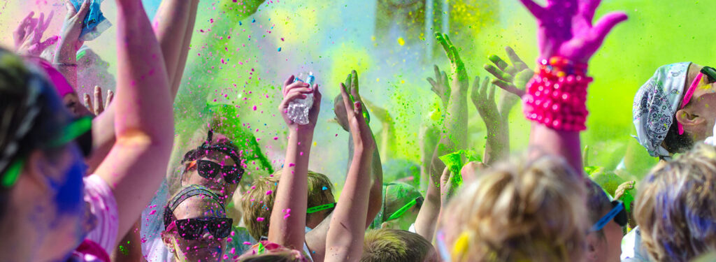 image of hands in the air and colour powder