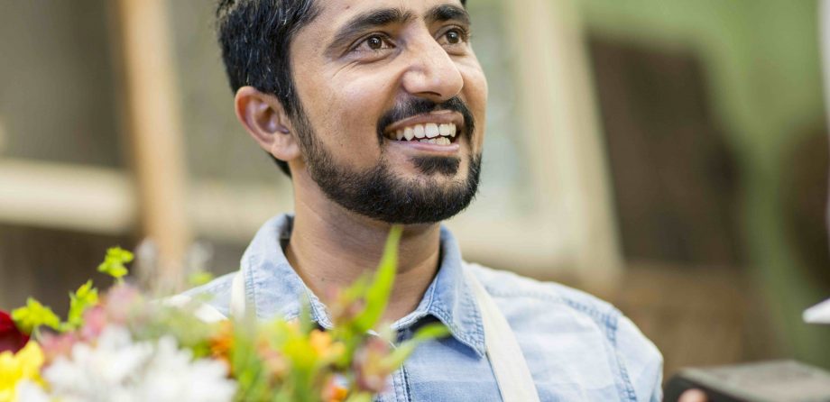 image of a man with flowers and smiling