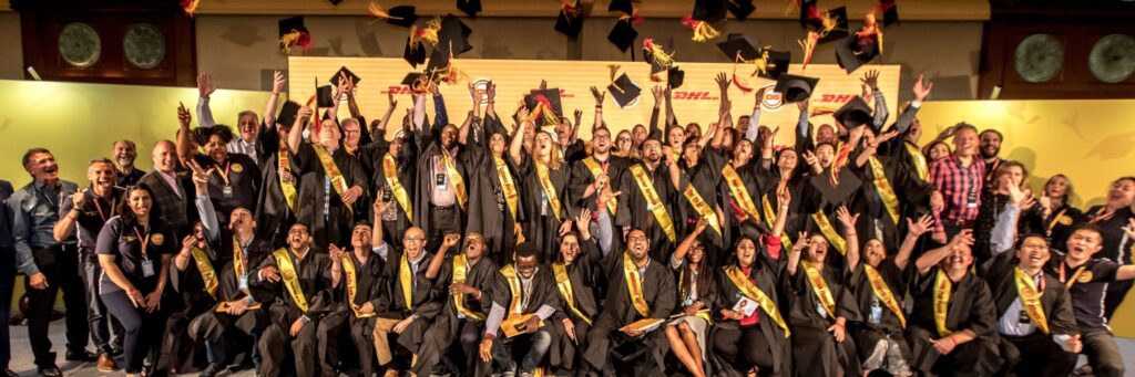 Engaged employees from DHL celebrating their CIM graduation and changing the world