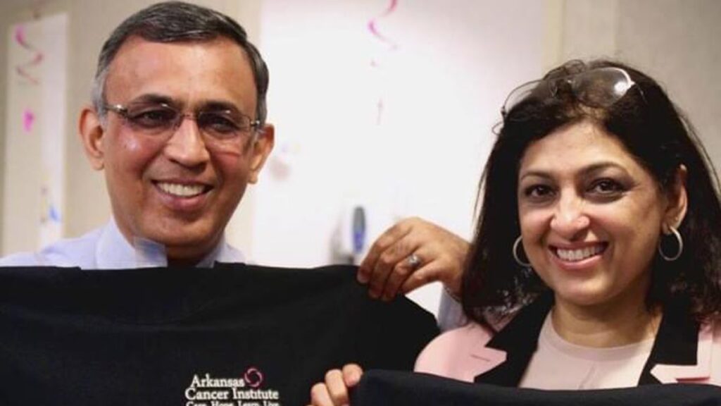 Picture of dr atiq and wife smiling holding up t-shirts