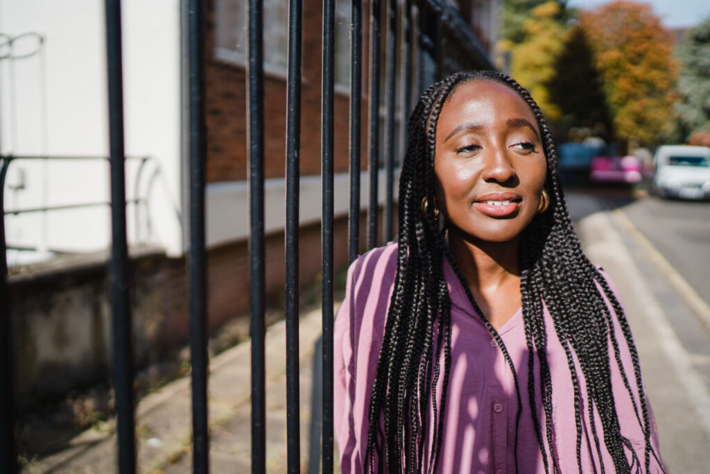 Picture of Lesley Owusu-Daaku leaning on a fence