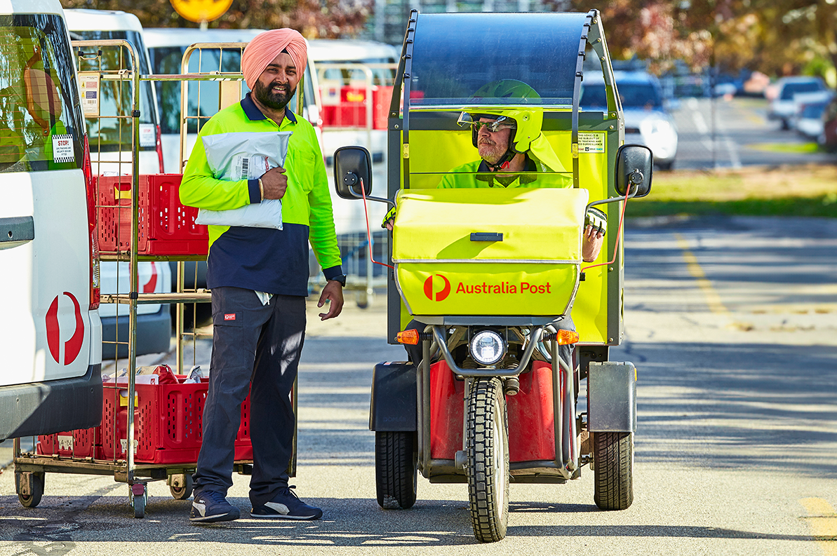 A picture of two Australia post employees on the street - this image is being used to demonstrate the nkd solution - safety culture